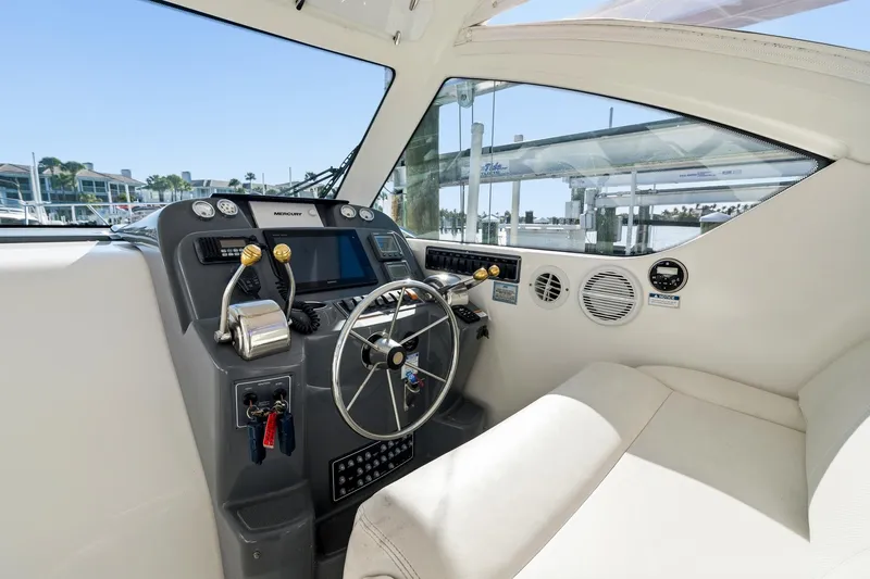 Slide: The Image of 2007 Tiara Yachts 3000 Open helm with steering wheel and control panel. - 6