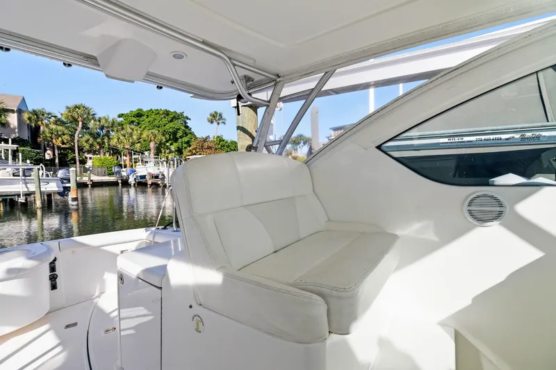 Slide: The Image of 2007 Tiara Yachts 3000 Open interior with white seating, dockside view. - 8