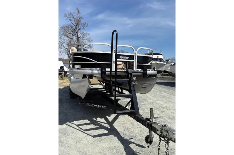 Slide: The Image of 2016 Sun Tracker Fishin' Barge 20 DLX on trailer, parked outdoors. - 3