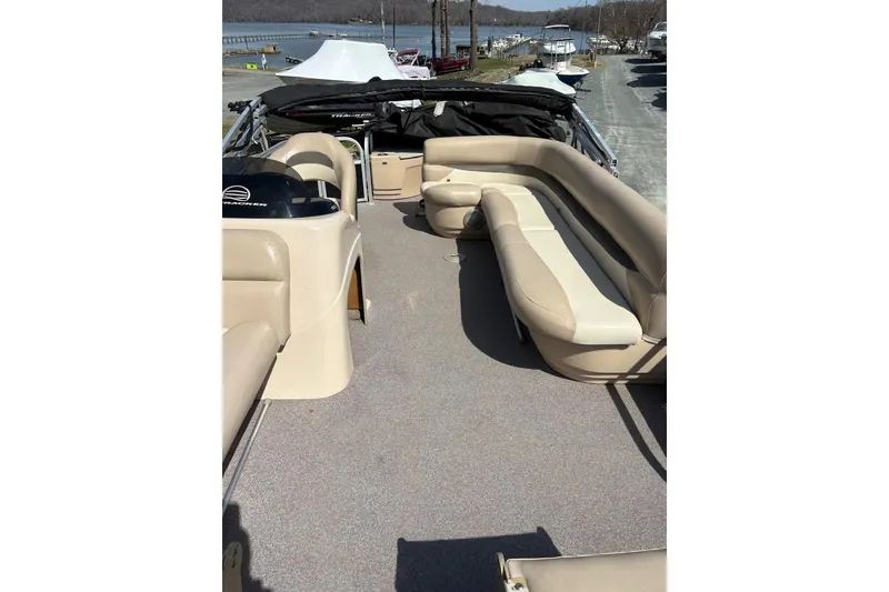 Slide: The Image of 2016 Sun Tracker Fishin' Barge 20 DLX interior with beige seating and open deck. - 8