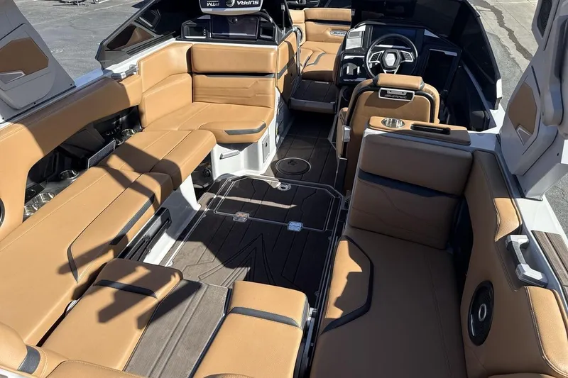 Slide: The Image of 2024 Supra SV boat interior with tan leather seating and modern dashboard design. - 10