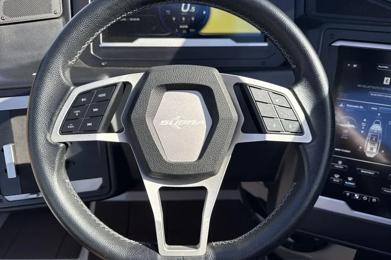 Slide: The Image of 2024 Supra SV steering wheel with control buttons and dashboard display. - 14