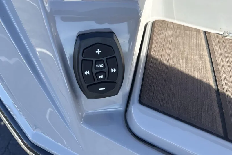 Slide: The Image of Control panel on 2024 Supra SV boat with audio buttons and wooden deck. - 27