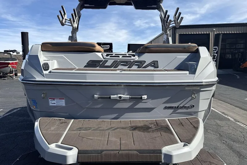 Slide: The Image of 2024 Supra SV boat rear view with swim platform and sleek design. - 4