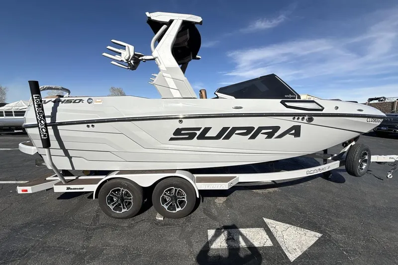 Slide: The Image of 2024 Supra SV boat on trailer, side view, showcasing sleek design and branding. - 6