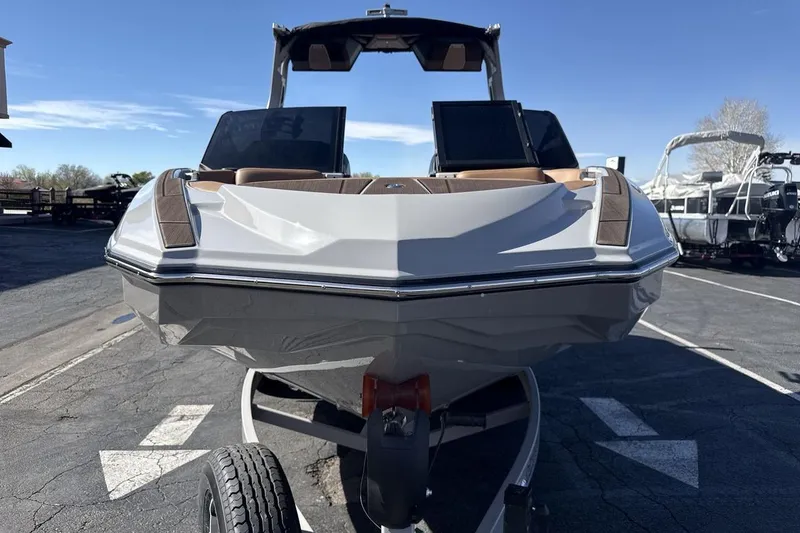 Slide: The Image of 2024 Supra SV boat on trailer, front view, parked outdoors. - 8