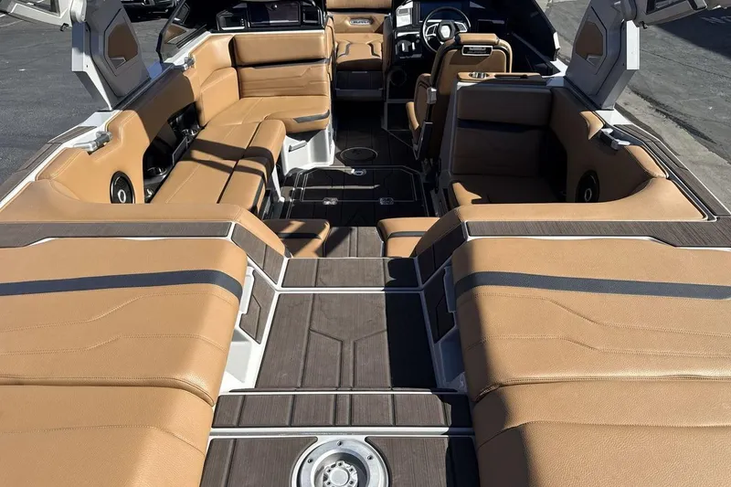 Slide: The Image of 2024 Supra SV boat interior with tan leather seating and modern dashboard design. - 9