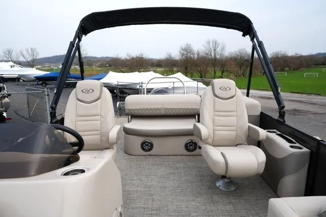 Slide: The Image of 2021 Harris Sunliner 230 pontoon boat interior with beige seating and canopy. - 10