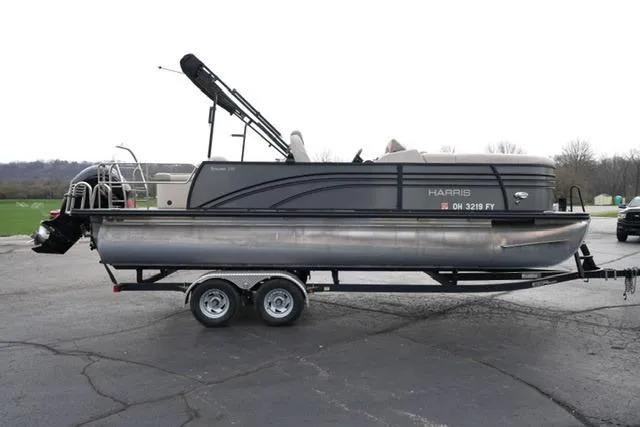 Slide: The Image of 2021 Harris Sunliner 230 pontoon boat on trailer, parked outdoors. - 4