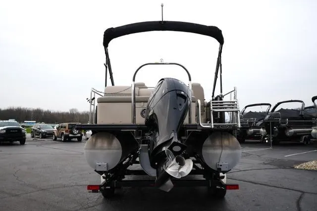 Slide: The Image of 2021 Harris Sunliner 230 pontoon boat with outboard motor, parked in a lot. - 6