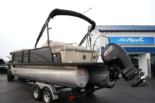 Slide: The Image of 2021 Harris Sunliner 230 pontoon boat with Mercury outboard motor on trailer. - 7