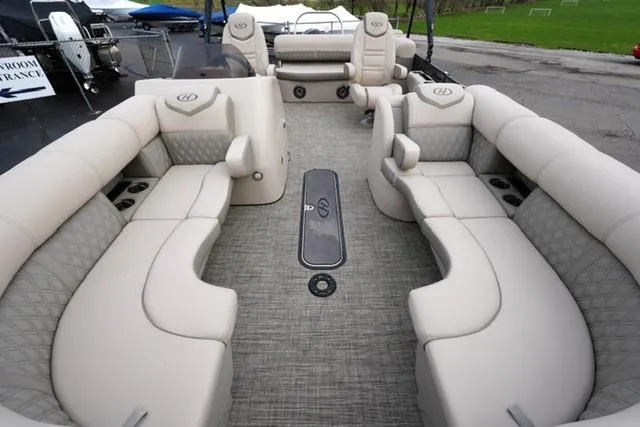 Slide: The Image of 2021 Harris Sunliner 230 pontoon boat with luxurious beige seating and spacious layout. - 9