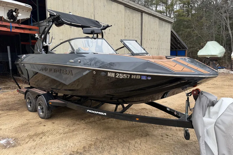 The Image of 2022 Moomba Kaiyen boat on trailer, parked outdoors near a wooden building. - 15