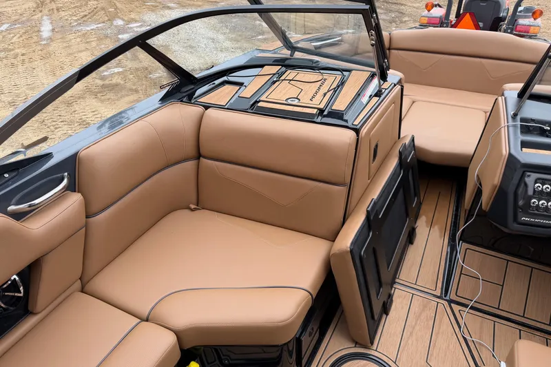 Slide: The Image of 2022 Moomba Kaiyen boat interior with tan leather seating and modern dashboard design. - 17