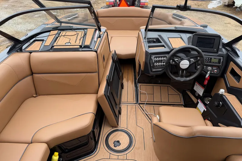 Slide: The Image of 2022 Moomba Kaiyen boat interior with tan seating and modern dashboard design. - 18