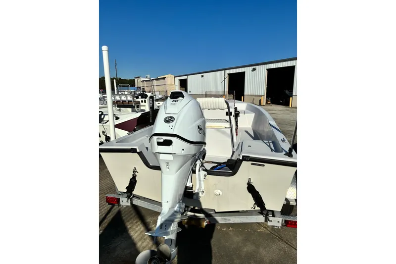 Slide: The Image of 2023 Stott Craft SCV 170 boat with outboard motor, parked outdoors. - 3