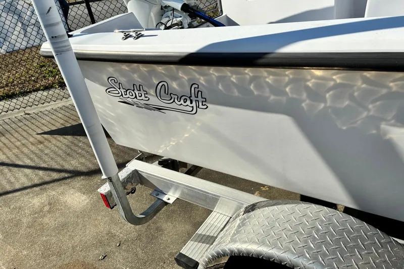 Slide: The Image of 2023 Stott Craft SCV 170 boat on trailer, sunlight reflecting on hull. - 5