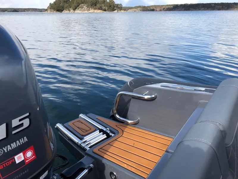 Slide: The Image of 2024 Northstar Orion 6 boat with Yamaha engine on a serene lake. - 10