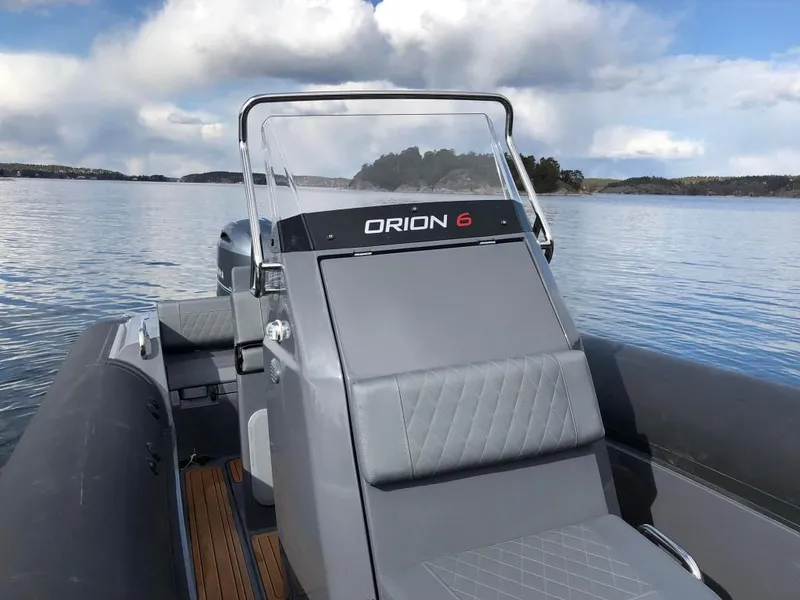 Slide: The Image of 2024 Northstar Orion 6 boat on calm water with scenic background. - 12