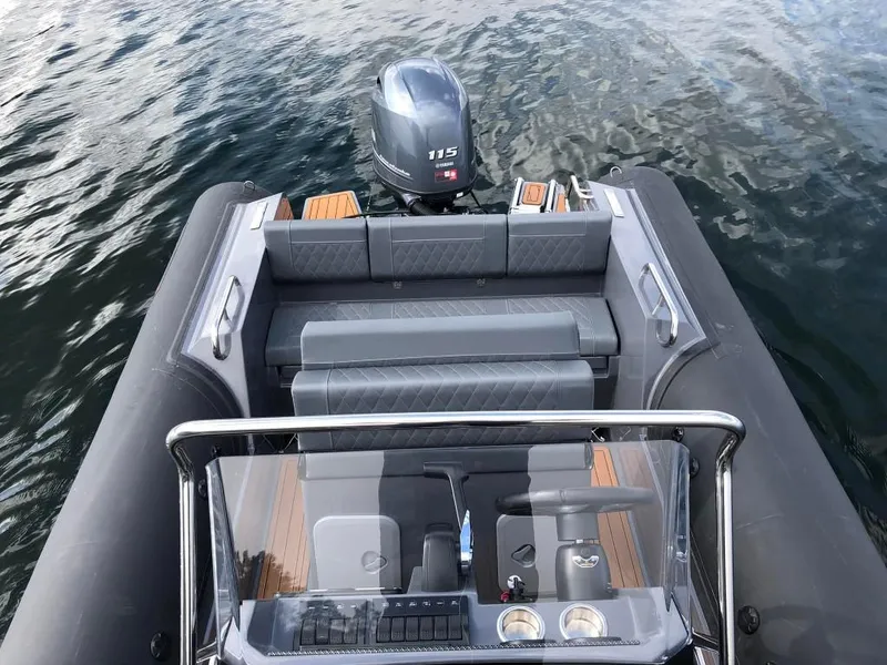 Slide: The Image of 2024 Northstar Orion 6 boat interior with 115 HP outboard motor on water. - 13