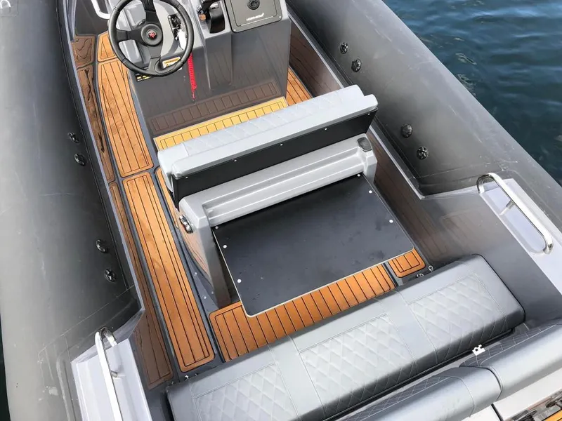 Slide: The Image of 2024 Northstar Orion 6 boat interior with teak flooring and cushioned seating. - 14