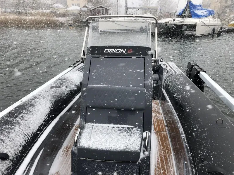 Slide: The Image of 2024 Northstar Orion 6 boat in snowy weather on a lake. - 6
