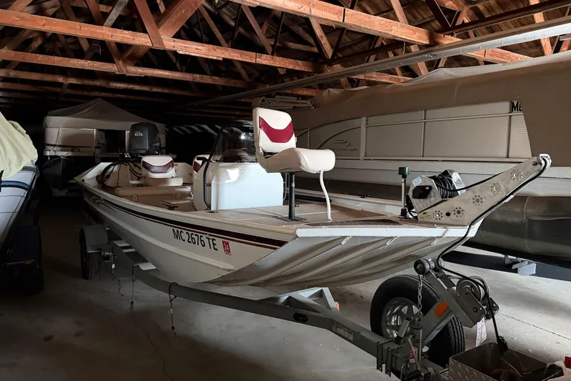 The Image of 2009 G3 1860 CC Deluxe boat stored in a wooden-roofed garage. - 0