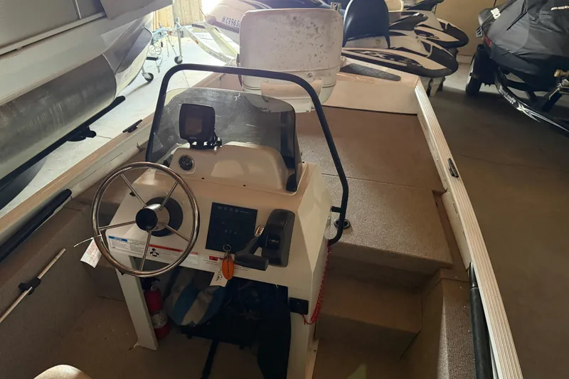 Slide: The Image of 2009 G3 1860 CC Deluxe boat interior with steering wheel and control panel. - 13