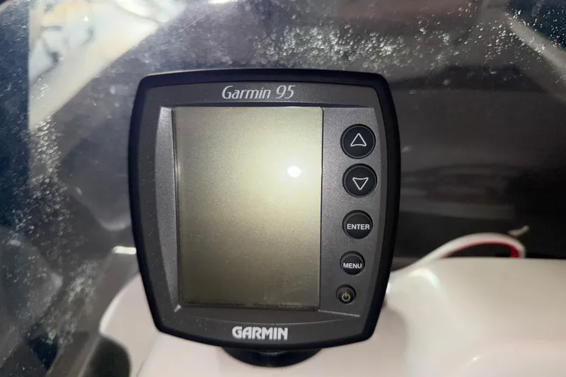 Slide: The Image of Garmin 95 GPS device on a 2009 G3 1860 CC Deluxe boat dashboard. - 14