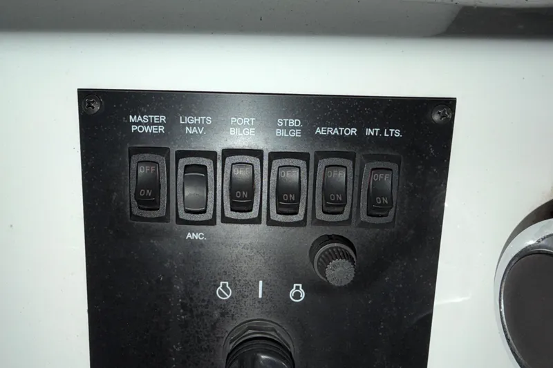 Slide: The Image of Control panel of a 2009 G3 1860 CC Deluxe boat with labeled switches. - 15
