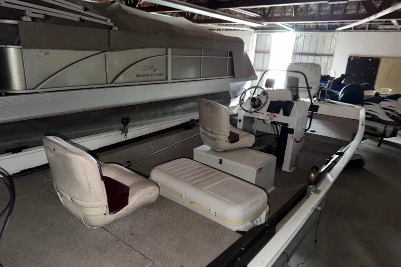 Slide: The Image of 2009 G3 1860 CC Deluxe boat interior with seating and steering console in storage. - 16