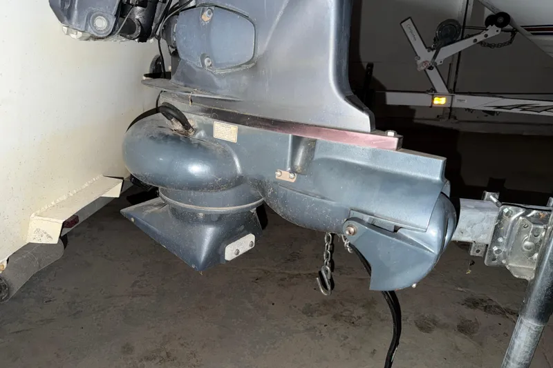 Slide: The Image of Outboard motor of a 2009 G3 1860 CC Deluxe boat in a garage setting. - 18