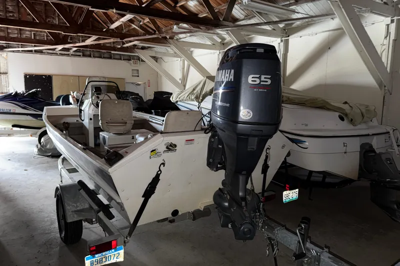 Slide: The Image of 2009 G3 1860 CC Deluxe boat with Yamaha 65 outboard motor in storage. - 2