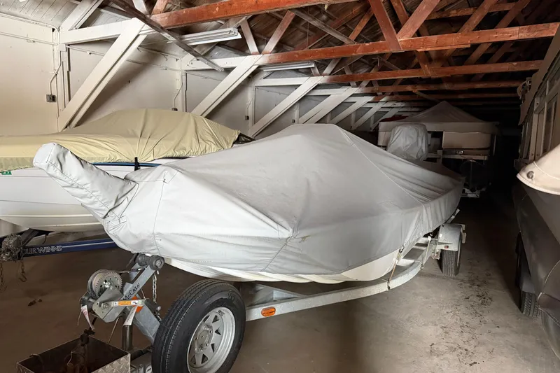 Slide: The Image of Covered 2009 G3 1860 CC Deluxe boat stored indoors on a trailer. - 4