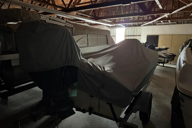Slide: The Image of Covered 2009 G3 1860 CC Deluxe boat stored in a dimly lit garage. - 6