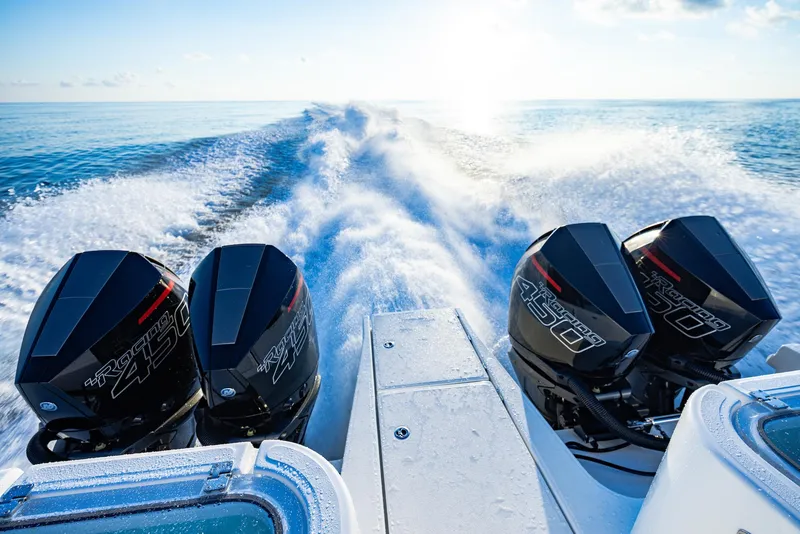 Slide: The Image of 2024 Aquila 47 Molokai with powerful outboard engines cruising on open water. - 11