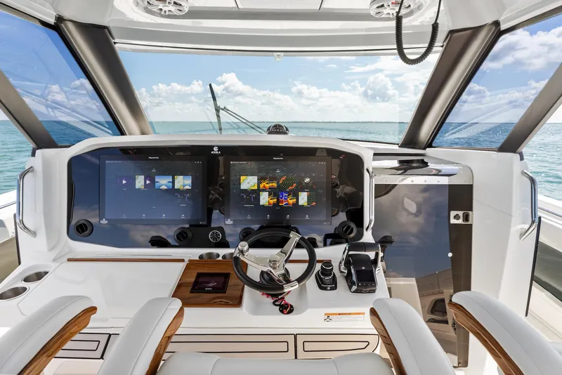 Slide: The Image of 2024 Aquila 47 Molokai yacht helm with advanced navigation displays and ocean view. - 15