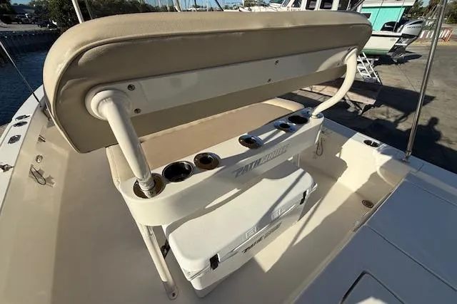 Slide: The Image of 2016 Pathfinder 2200 TRS boat with cushioned seating and rod holders on deck. - 12