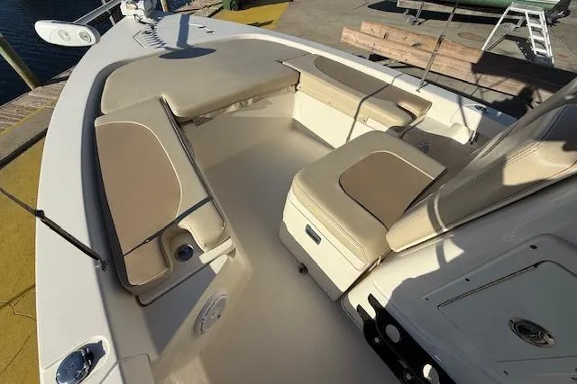 Slide: The Image of 2016 Pathfinder 2200 TRS boat interior with beige seating and storage compartments. - 13