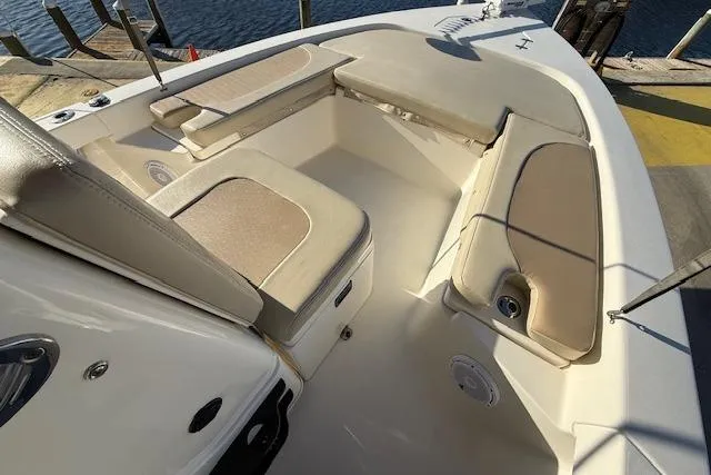 Slide: The Image of 2016 Pathfinder 2200 TRS boat interior with beige seating and storage compartments. - 14