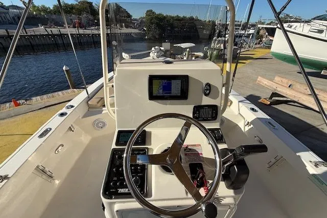 Slide: The Image of 2016 Pathfinder 2200 TRS boat console with steering wheel and navigation equipment. - 16