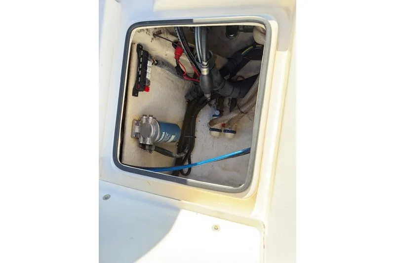 Slide: The Image of 2016 Pathfinder 2200 TRS boat compartment with wiring and components visible. - 24