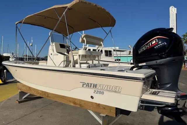Slide: The Image of 2016 Pathfinder 2200 TRS boat with Yamaha engine, docked under a canopy. - 4