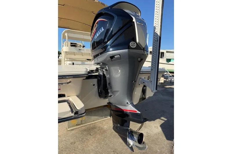 Slide: The Image of 2016 Pathfinder 2200 TRS boat with Yamaha outboard motor, docked outdoors. - 6