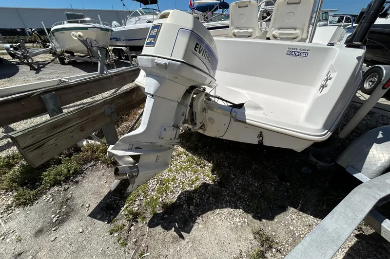 Slide: The Image of 1996 Wellcraft 190 CCF boat with Evinrude outboard motor in a marina setting. - 3