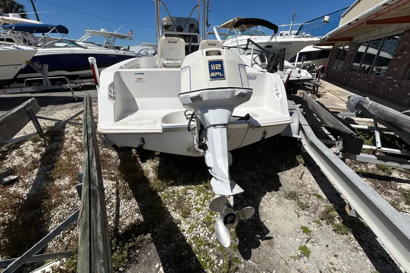 Slide: The Image of 1996 Wellcraft 190 CCF boat with outboard motor on trailer, parked outdoors. - 4