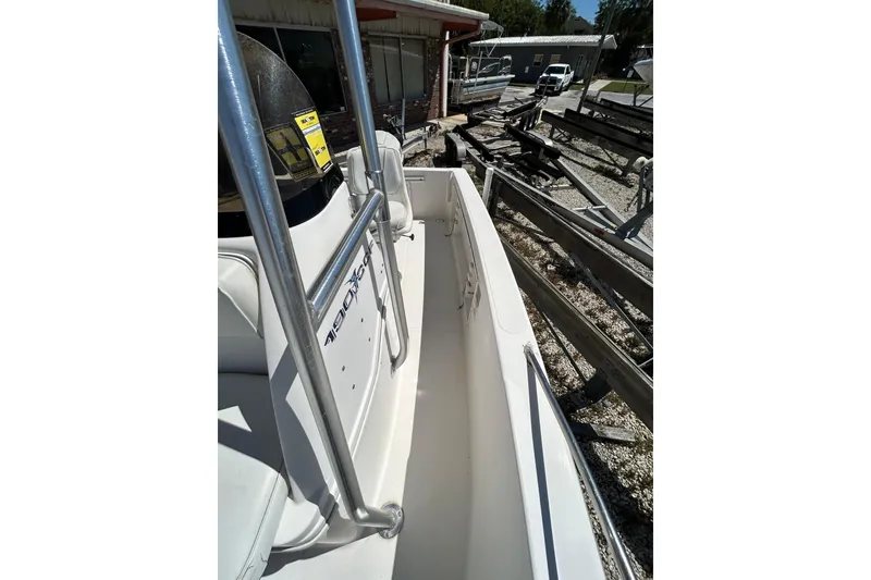 Slide: The Image of 1996 Wellcraft 190 CCF boat, white interior, metal railings, parked outdoors. - 7