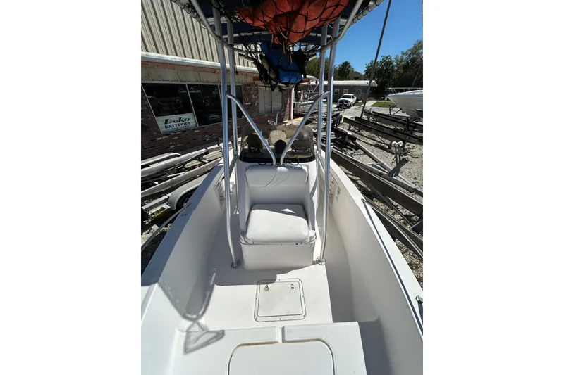 Slide: The Image of 1996 Wellcraft 190 CCF boat interior with seating and console, parked outdoors. - 8