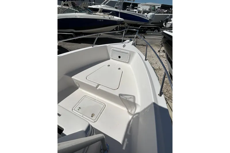 Slide: The Image of 1996 Wellcraft 190 CCF boat deck with storage compartments, surrounded by other boats. - 9