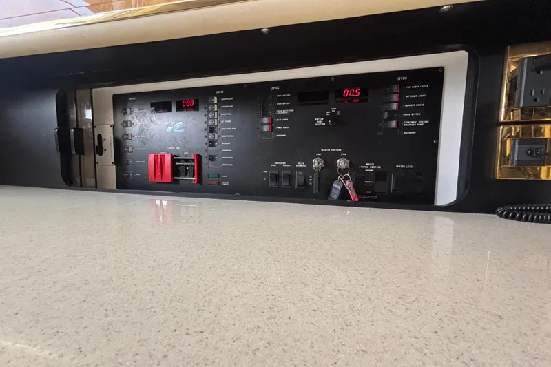 Slide: The Image of Control panel of a 1998 Sea Ray 500 Sundancer yacht, featuring various switches and indicators. - 11